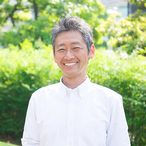 middle age man smiling in park after getting root canal