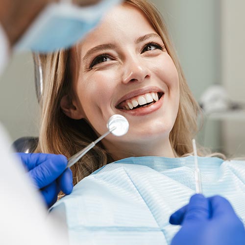 a woman at a dental hygiene appointment gets a dental exam in Mississauga